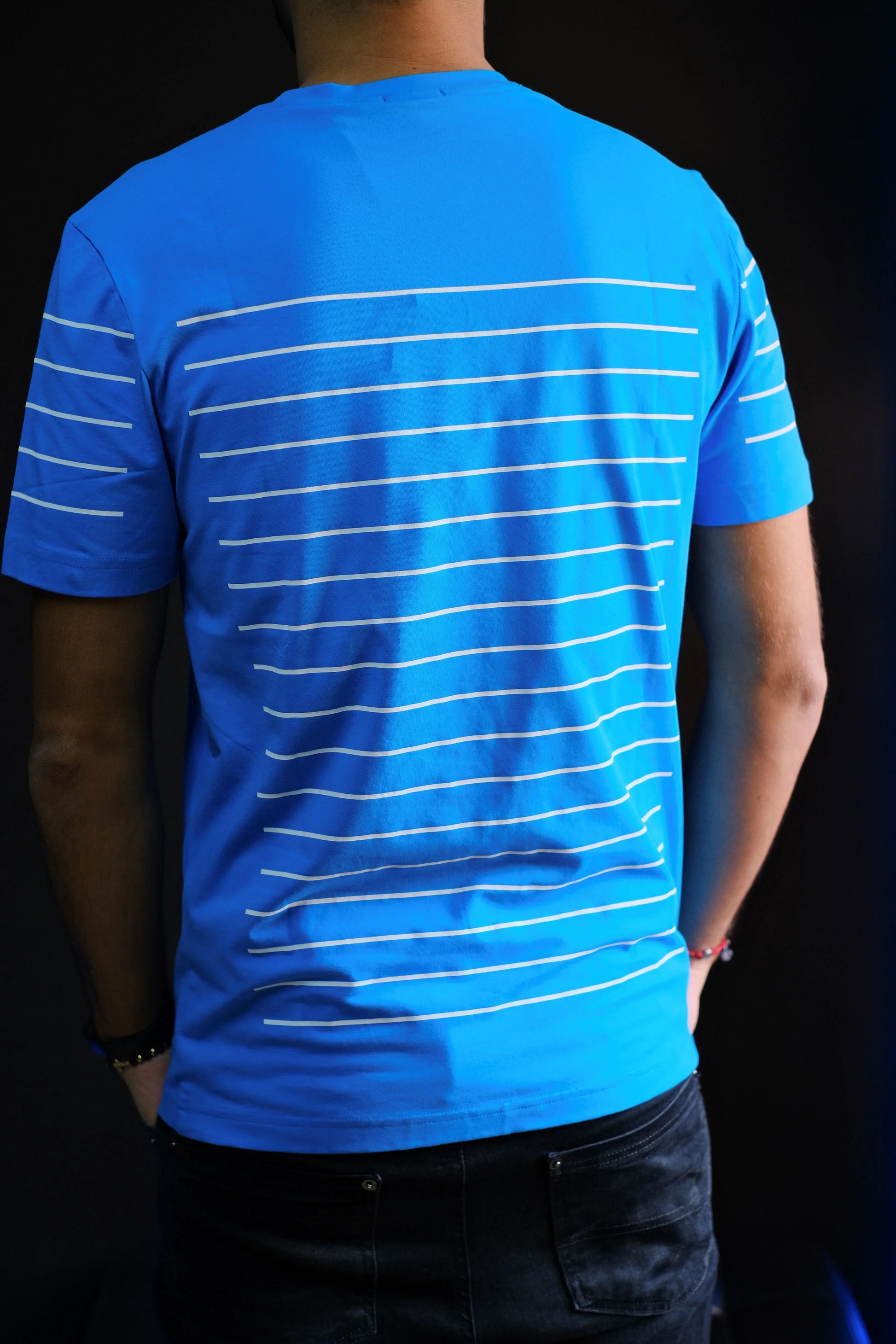 Camiseta azul de hombre con líneas blancas horizontales en la espalda, estilo casual moderno