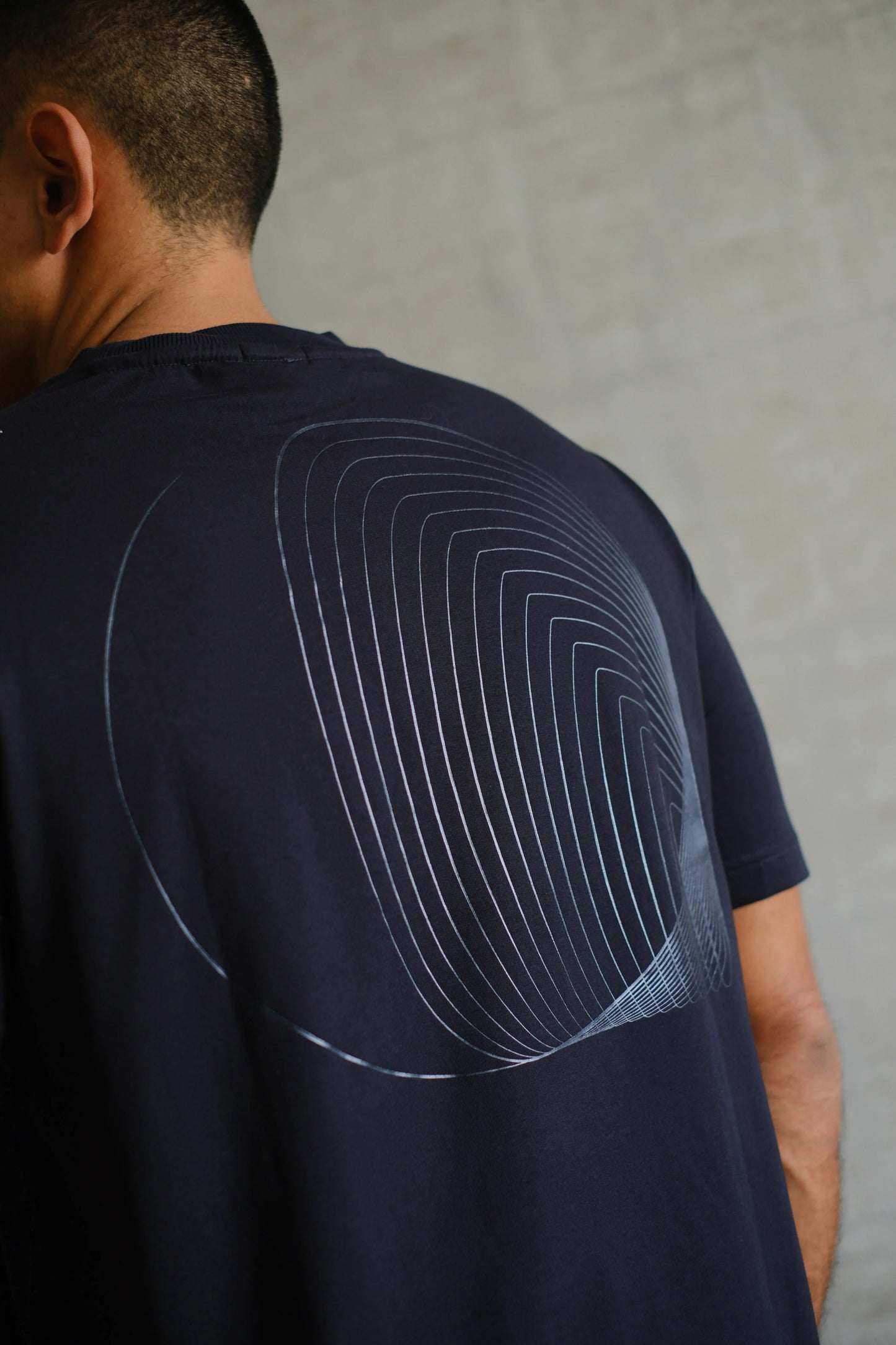 Camiseta negra con diseño geométrico moderno en la espalda, estilo casual para hombre